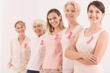 5 women wearing Breast Cancer awareness ribbons