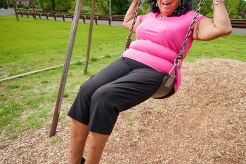 Senior woman enjoying a swing in the garden