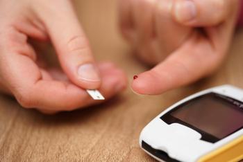 Close up of person testing their blood sugar.