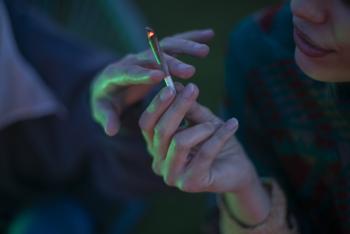 two adults passing cigarette