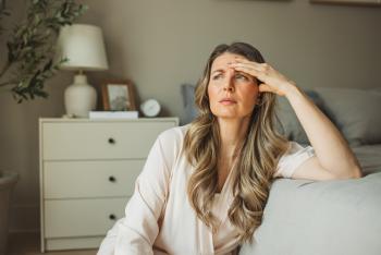 mid age woman sitting worried bedside