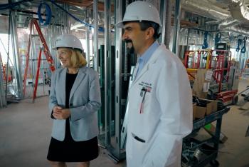 two people standing in construction area