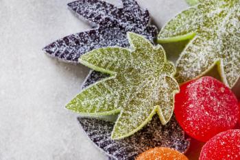 Candies in the shape of cannabis leaf kept on table
