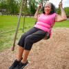 Senior woman enjoying a swing in the garden